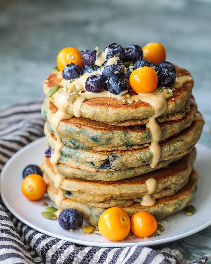 Fluffy Whole Grain Blueberry Pancakes! Delicious and fluffy with the added benefit of extra fiber from the whole grain flour.