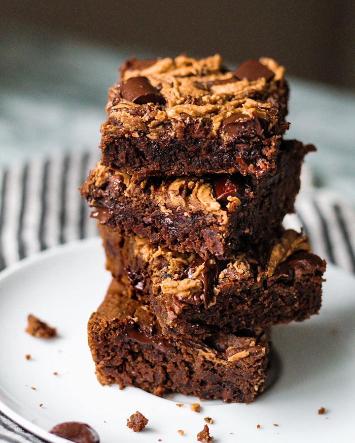 Four plated black bean brownies that are stacked up on top of each other. 