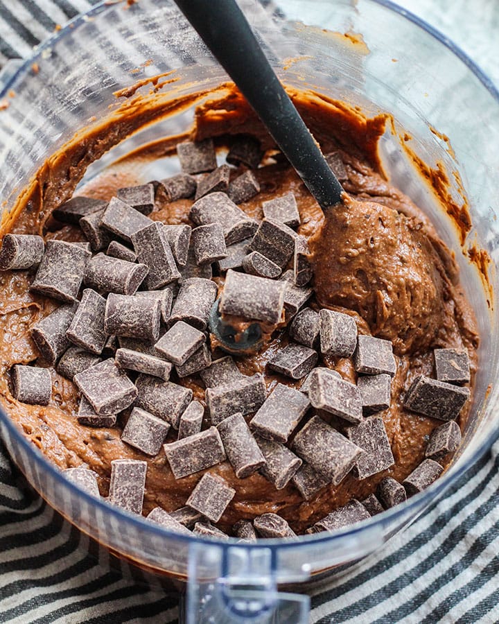 Folding chocolate chips into brownie batter.