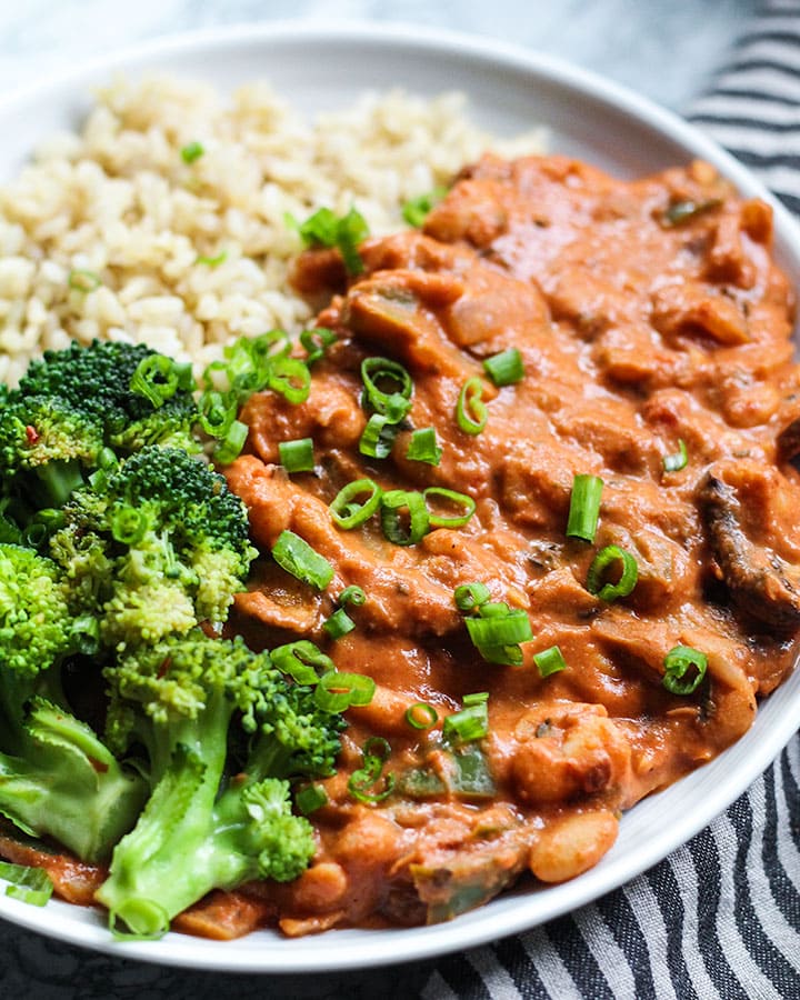 Angle shot of cannelini stew with broccoli and brown rice.