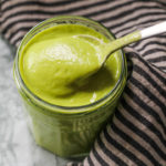 Green dressing in jar with spoon.