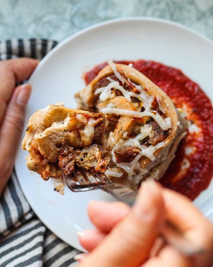 These vegan "meatball" pizza pinwheels are all the things you love about pizza, rolled up into a delicious bun that is satisfying cheesy and loaded with flavor. These pizza pinwheels are fun to make, full of fiber and plant based protein. #pizza #veganrecipes #easyrecipes #veganpizza | plantbasedrdblog.com