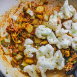 Cauliflower added to curry spices, onions and garlic and ginger.