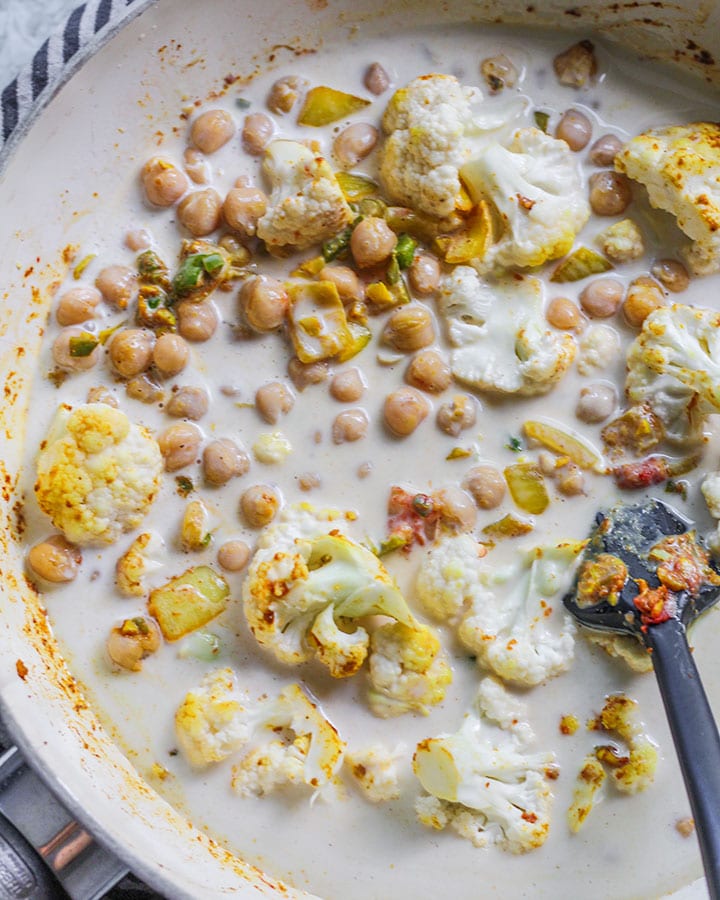 Coconut milk added to curried chickpea mixture.