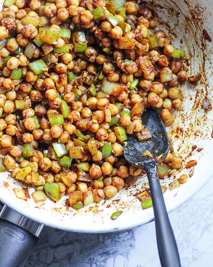 Mustard chili chickpeas fully cooked in pan.