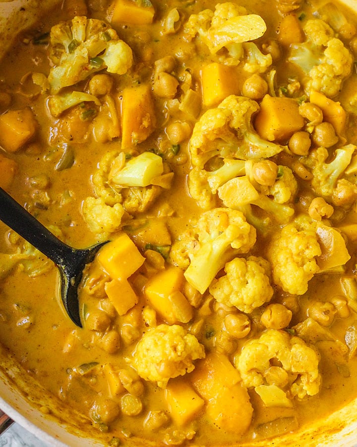 Fully cooked mango coconut chickpea curry and thickened.