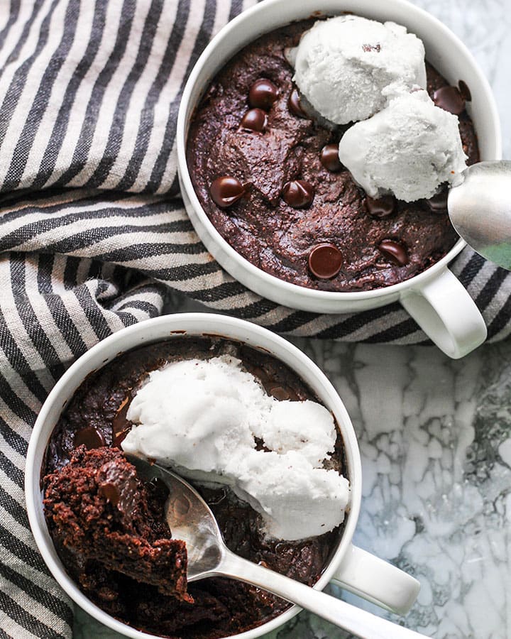 Cooked brownie mug topped with vegan ice cream.