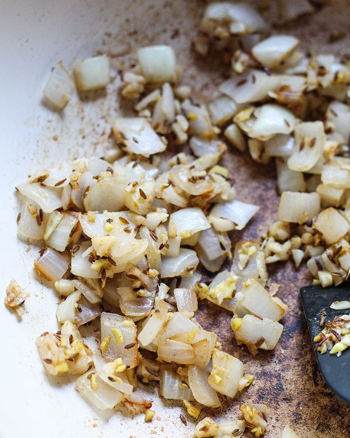 Onions, garlic, ginger and spices cooking in a pan.