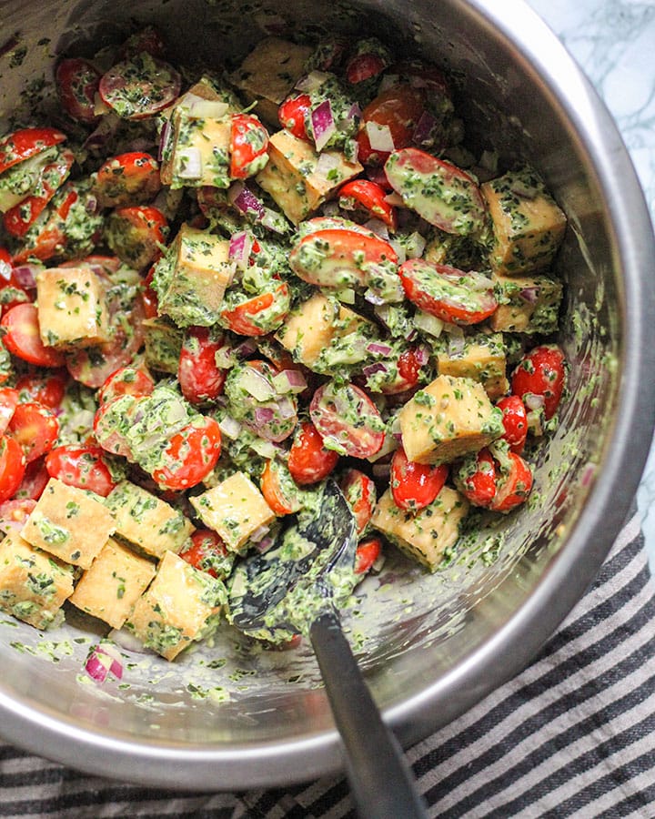 Up close mixing bowl with pesto tofu salad.