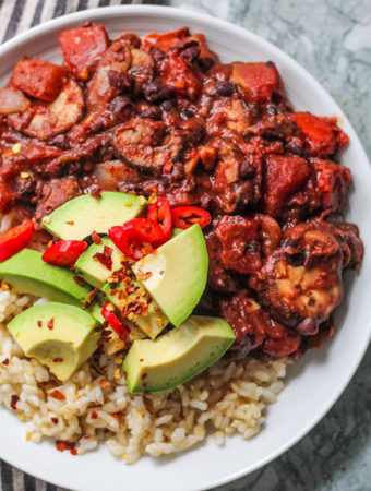 Stewed black beans paired with brown rice, avocado and chili peppers.