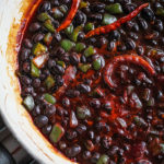 All ingredients of maple cayenne black beans simmering together in a pan.