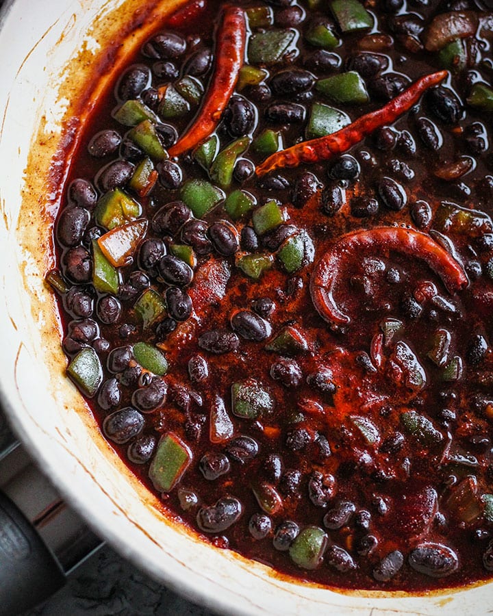 All ingredients of maple cayenne black beans simmering together in a pan.
