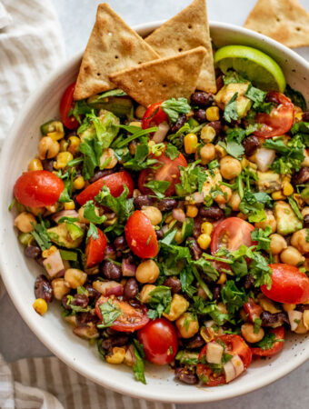 Serving the southwest chickpea and black bean salad with pita chips and extra lime wedges.