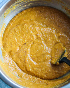 Wet ingredients for pumpkin bread batter all mixed together in mixing bowl.