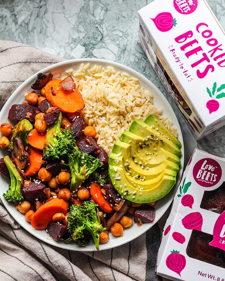 Bowl of stir fry vegetables paired with boxes of Love Beets.