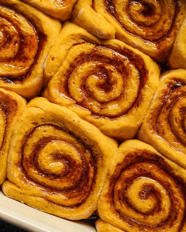 Cinnamon rolls in a baking dish after rising a second time.