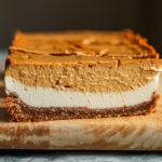 A side view of the two layers of cheesecake in one, the layer of vanilla cheesecake on the bottom and the pumpkin cheesecake layer on top.