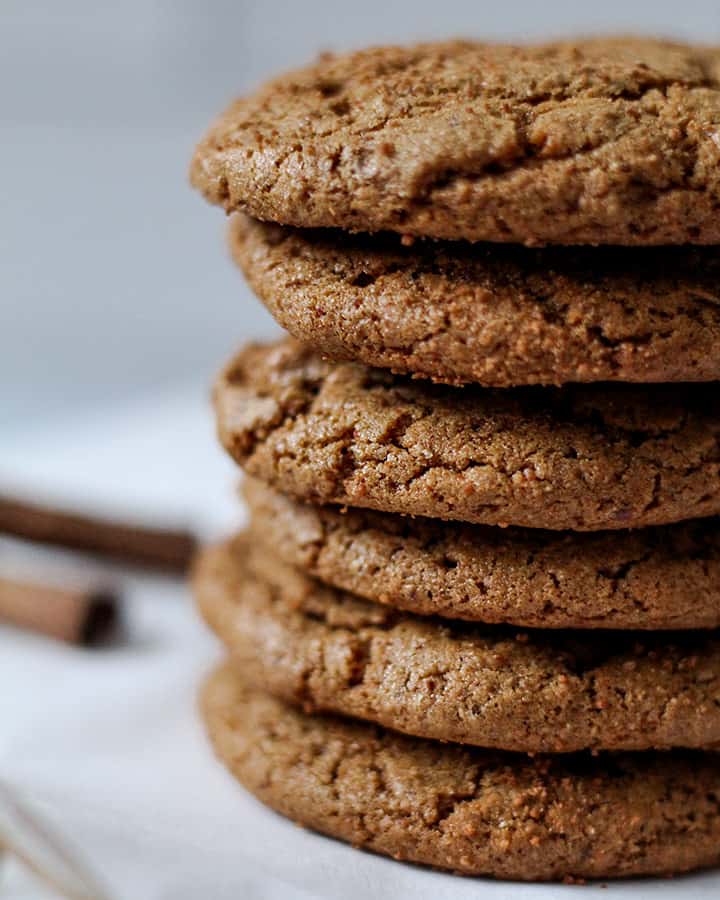 Close up of the cookie stack with cinnamon sticks faded in the background.
