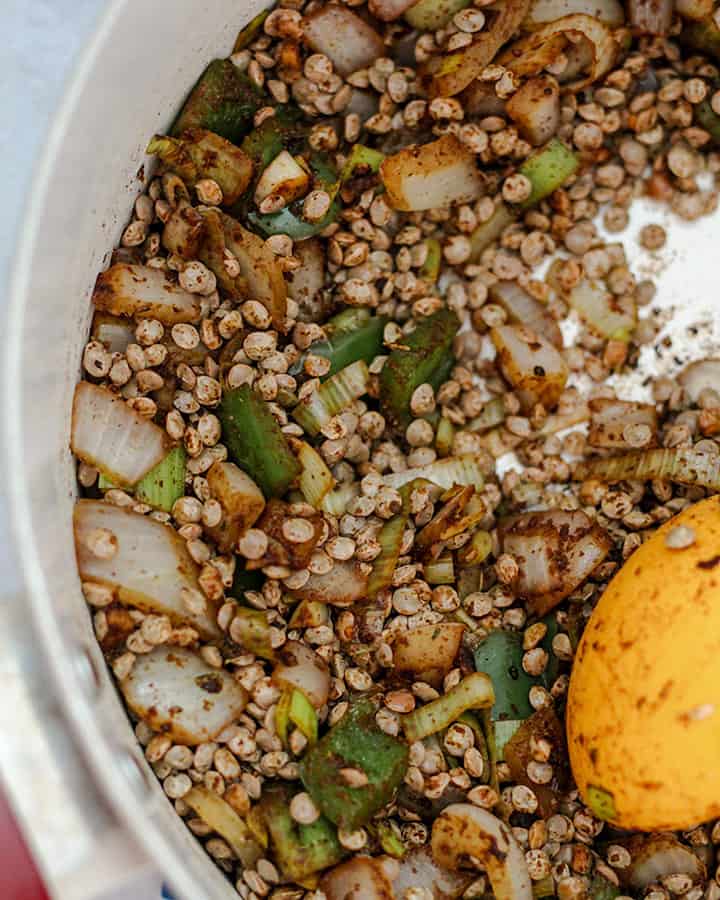 Stirring the lentils together with the spices, onions and bell pepper. 