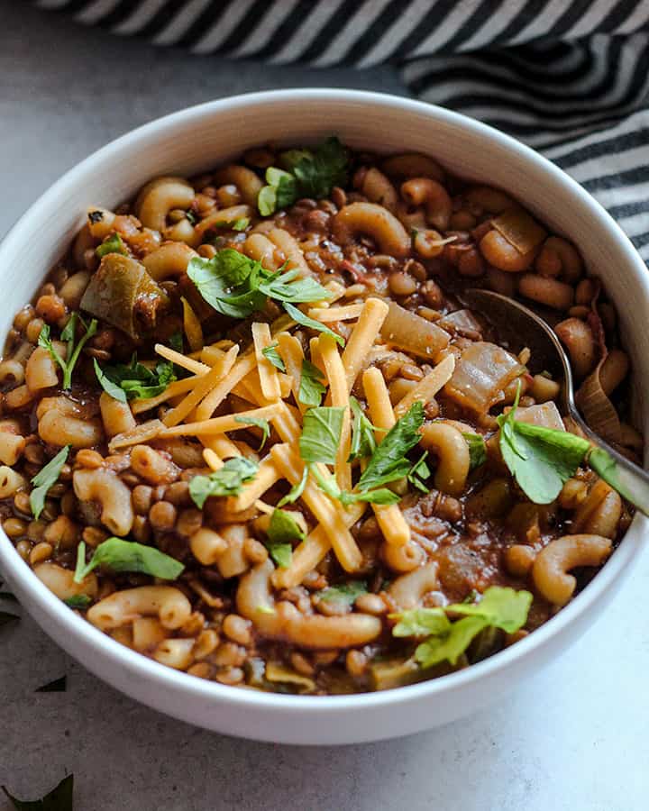 Side view of the lentil soup with a spoon tucked in for a bite.