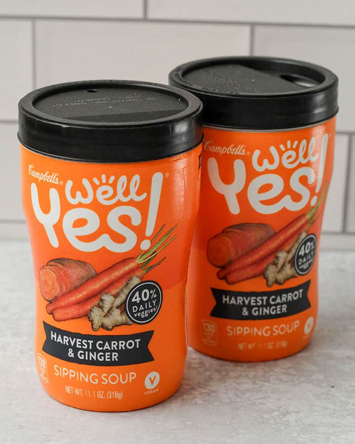 Two sipping soup cups sitting side by side on a bright grey counter.