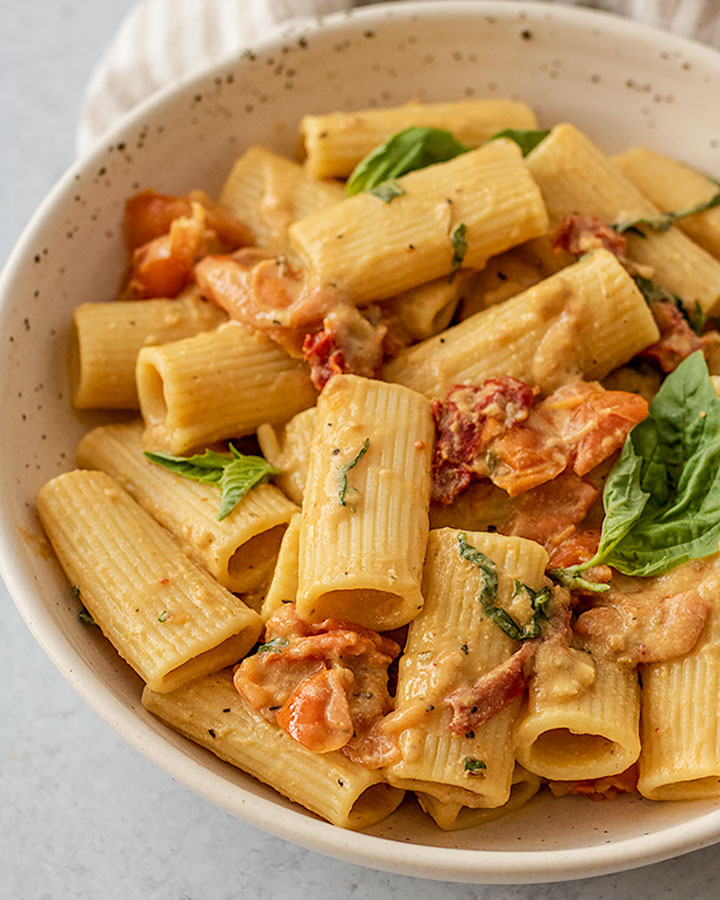 Front view of the hummus pasta and basil.