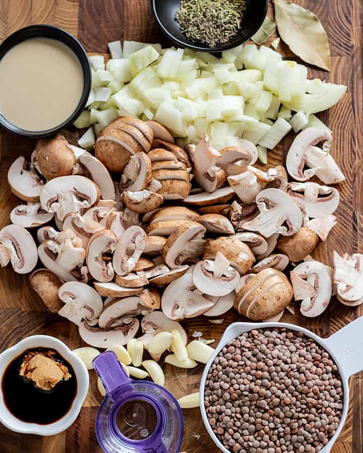 Cutting board with main ingredients of the lentil mushroom stew.