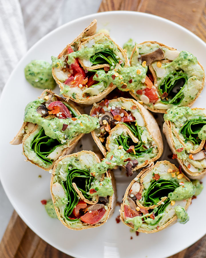 Plate of pinwheels on a cutting board.