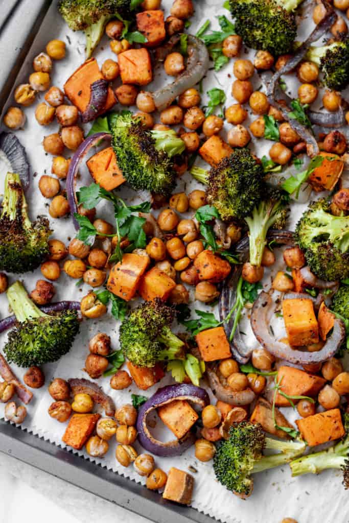 Vegetables and chickpeas right out of the oven after they finished roasting on a sheet pan.