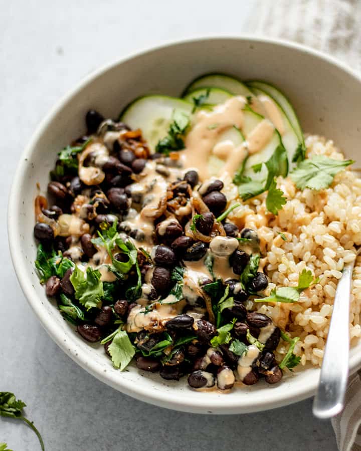 Side of the black bean nourish bowl with a spoon tucked into it.