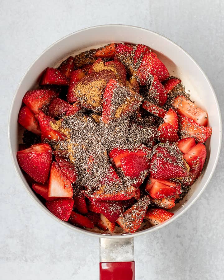 Fresh strawberries being cooked down with some chia seeds.