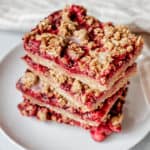 Plate of crumble bars topped with lemon icing.