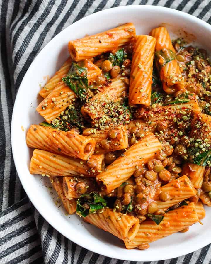 Pasta with lentils tossed with a tahini red sauce.