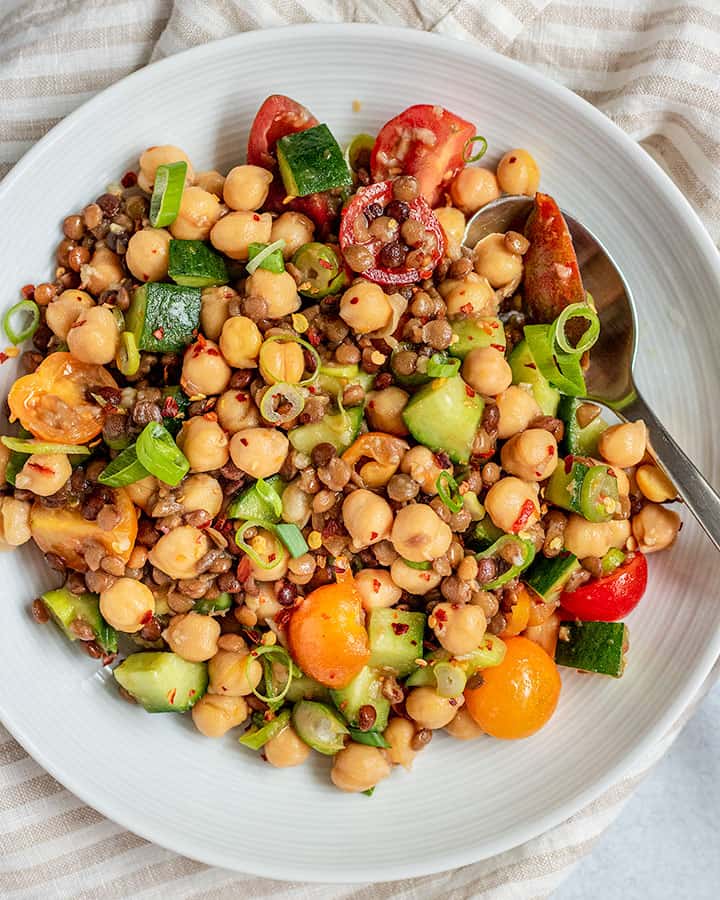 Plate of lentil and chickpea salad marinated in dressing.