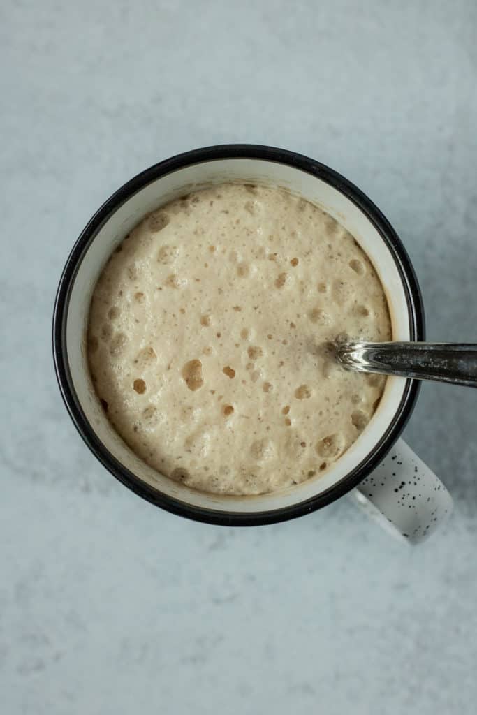 Yeast activating and fluffing up in a mug.