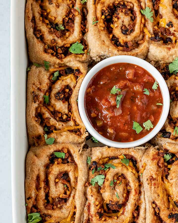 Top down view of the pinwheels served with salsa.