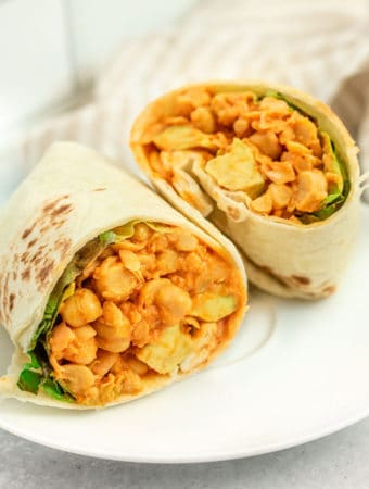Chickpea wraps filled with curry peanut chickpeas, lettuce and avocado.