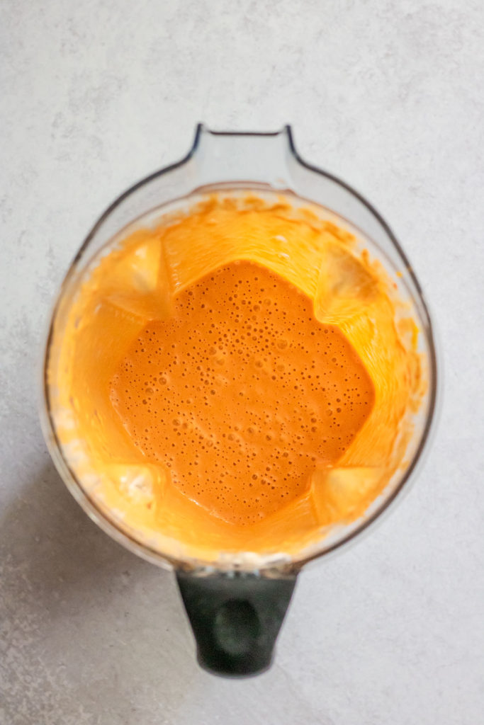 Blender with blended chipotle orange sauce.