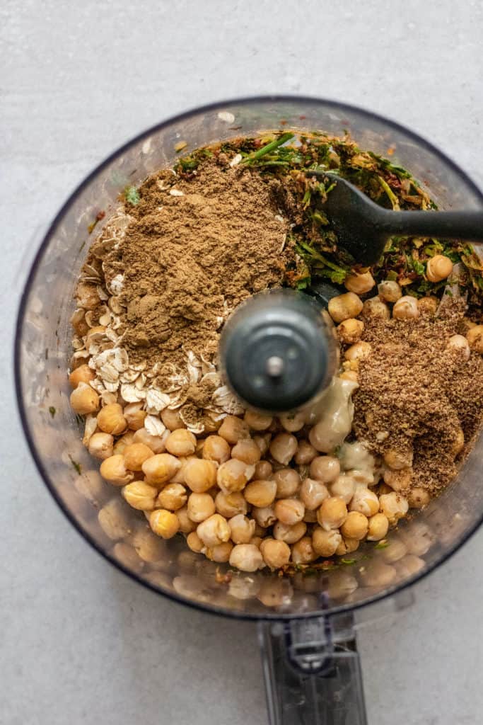 Chickpeas, spices and tahini added to the processing bowl.