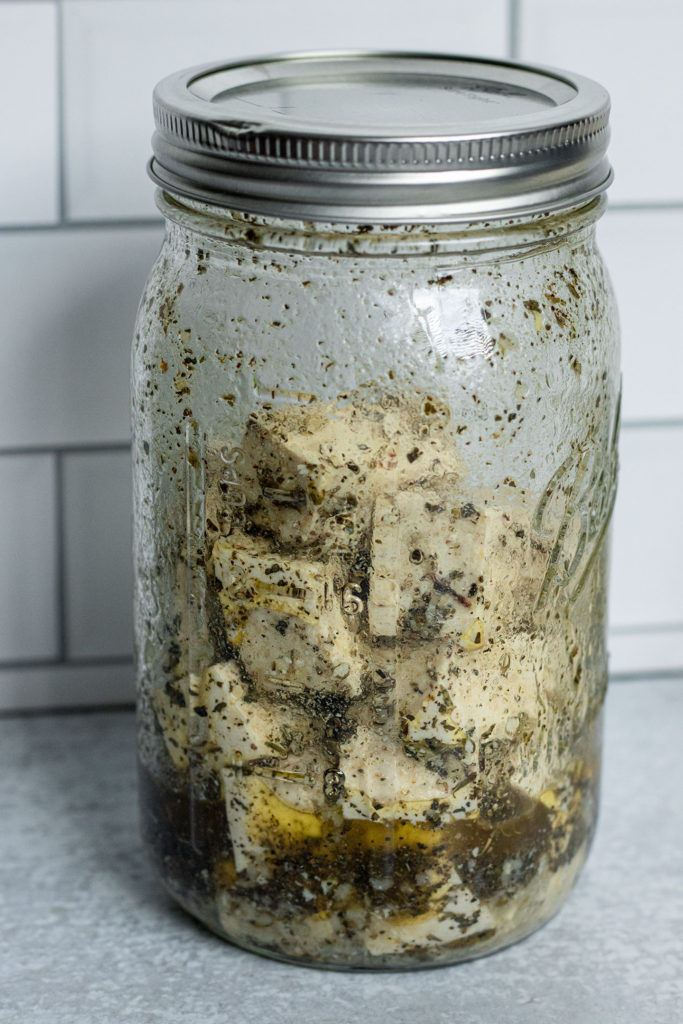 A large mason jar of marinating tofu.