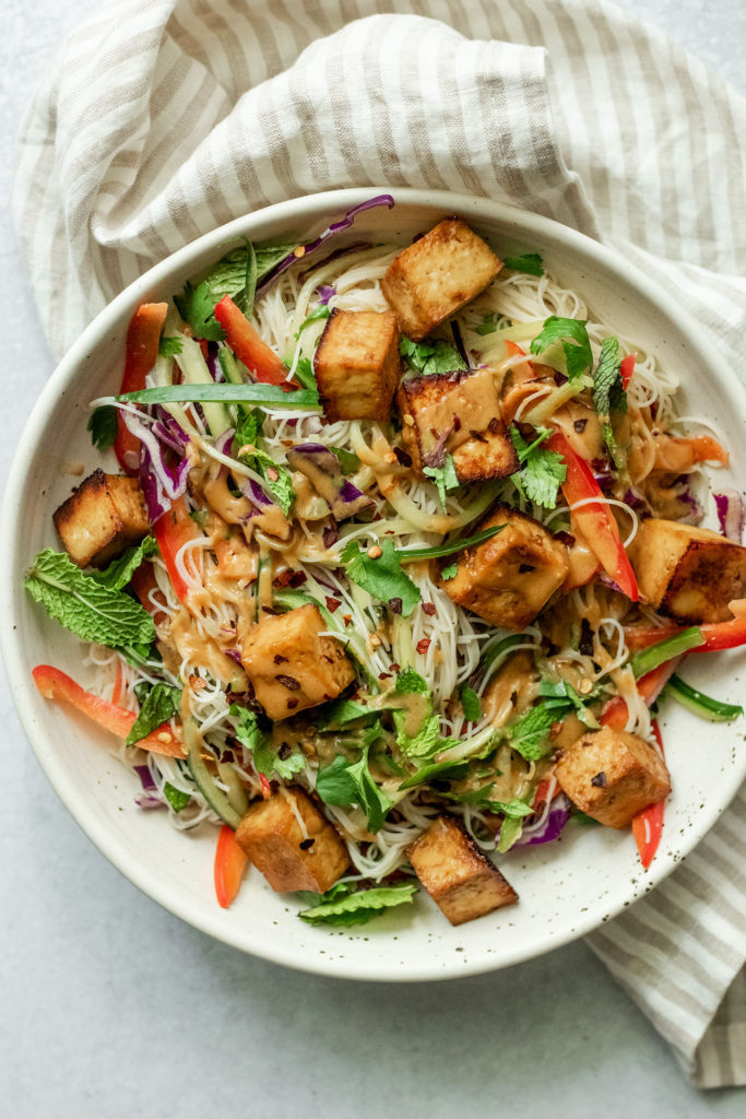 Plate of vermicelli noodles topped with sweet hoisin tofu and more peanut sauce.