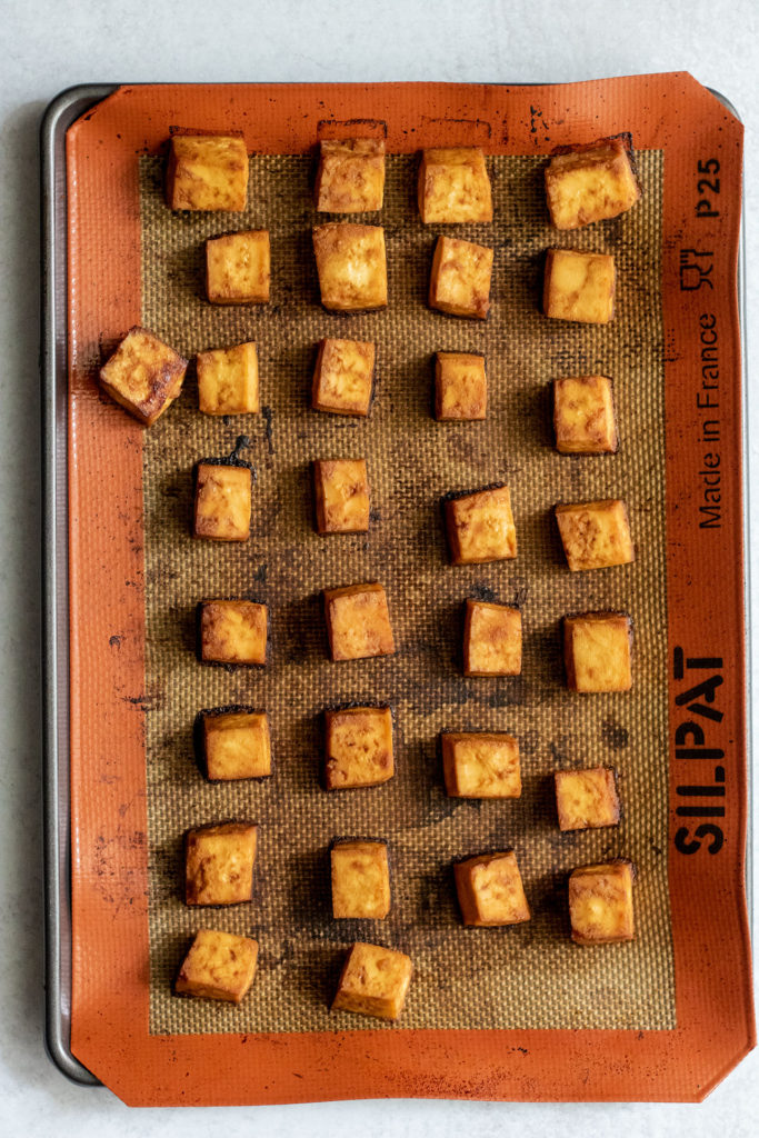 Baking sheet filled with baked sweet hoisin tofu.