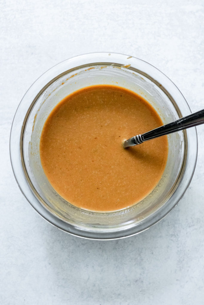 Peanut sauce mixed together in a glass bowl.
