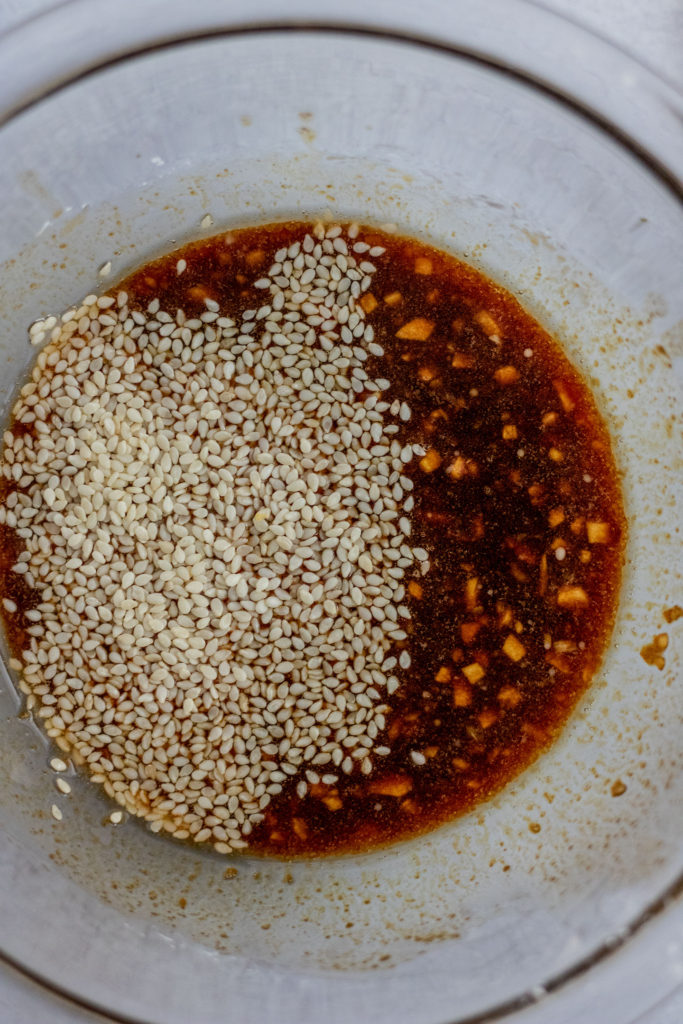 Garlic Ginger Sauce being mixed together in a small glass bowl.