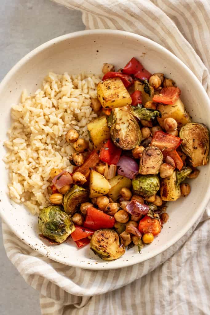 Bowl of rice served with the freshly roasted brussels sprouts and chickpeas.