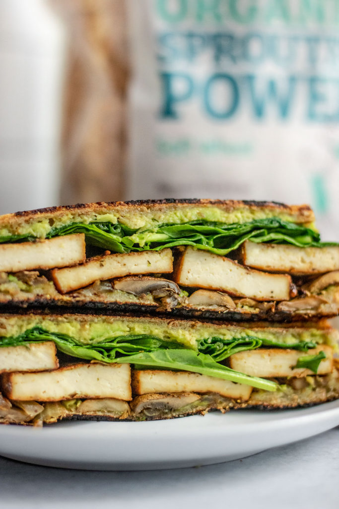 Tofu sandwich stacked on top of each other in front of a bag of Silver Hills food.