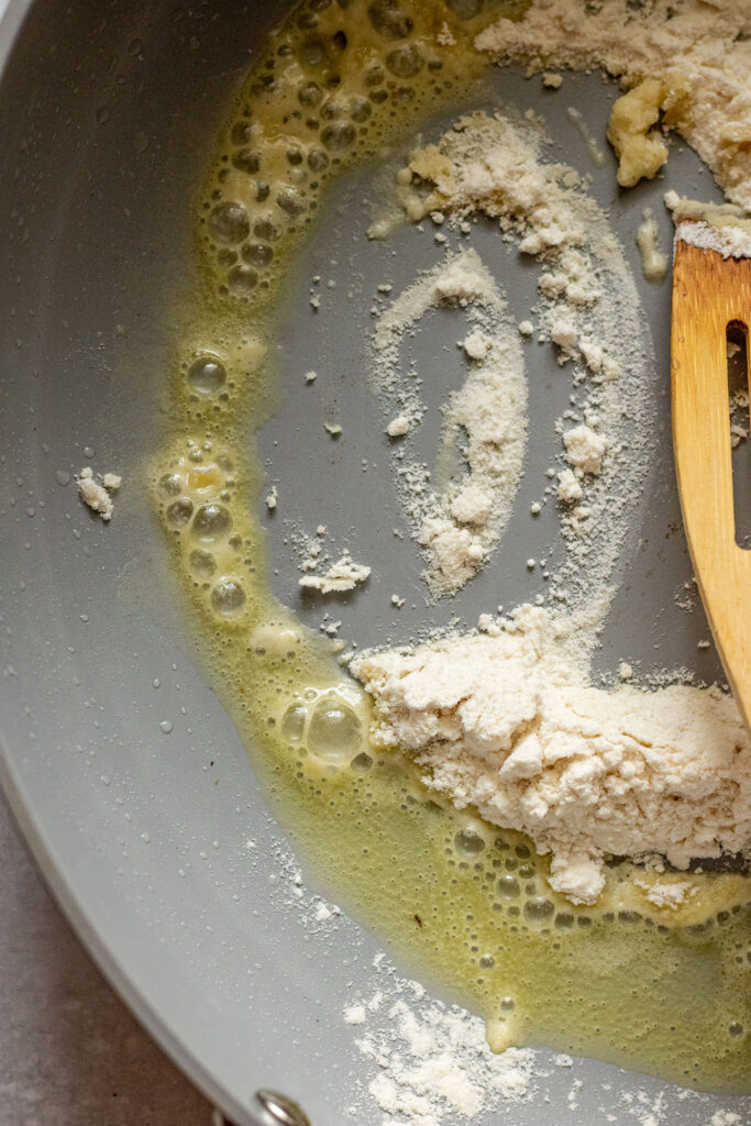Cooking flour with oil in a pan.