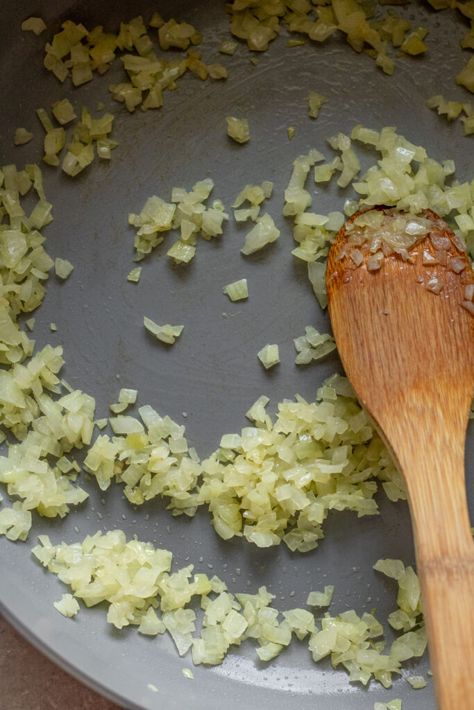 Minced onions sautéed in a pan.