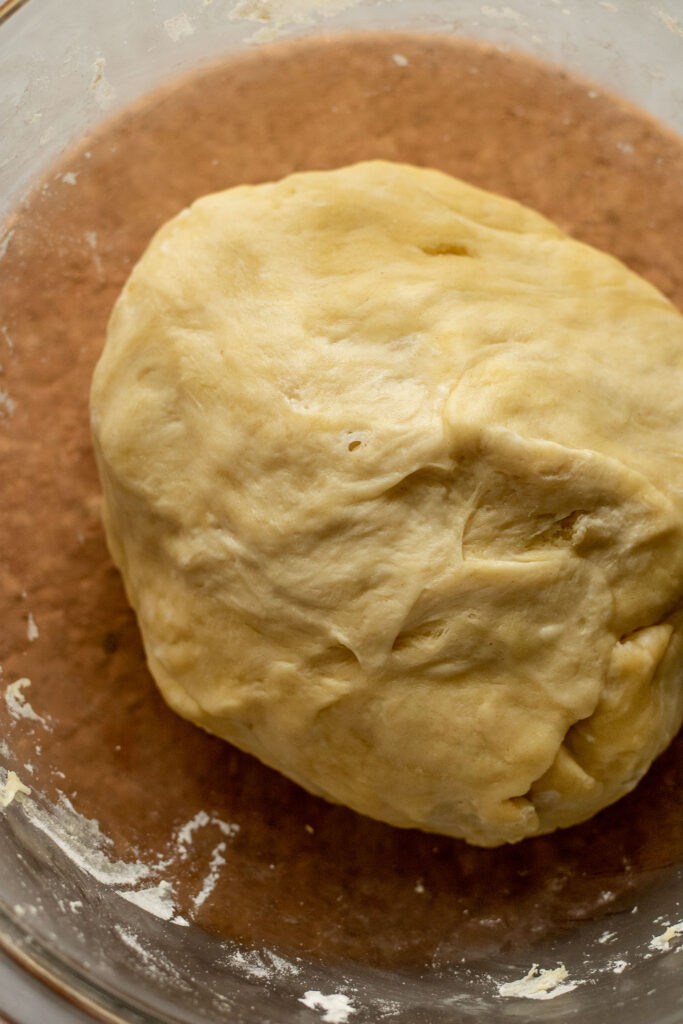 Smooth dough after resting in a greased bowl.