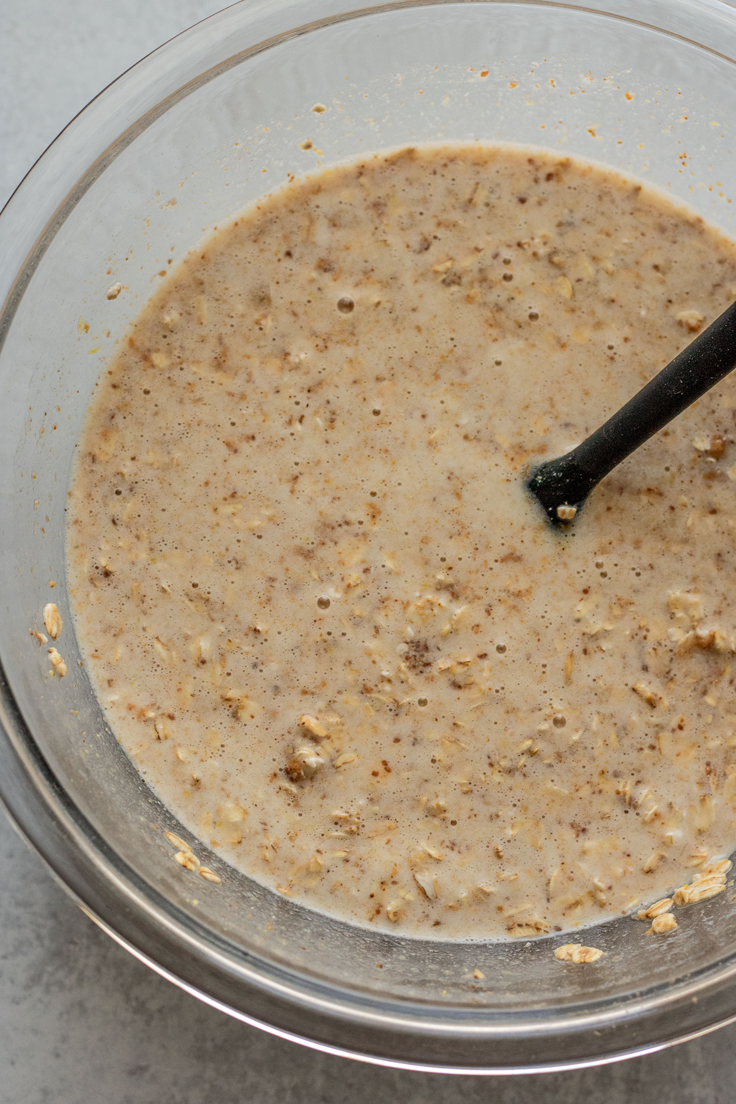 Mixing all the liquids together with the dry ingredients to make the lemon oat batter.